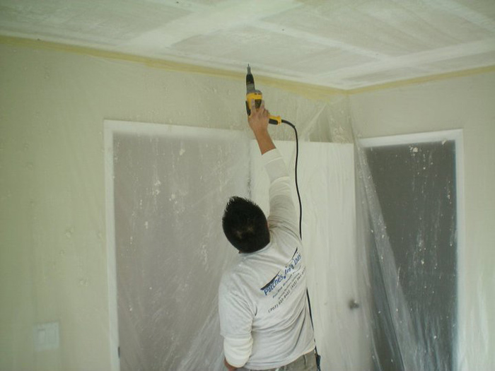 Inspecting cracked wall and ceiling for water damage