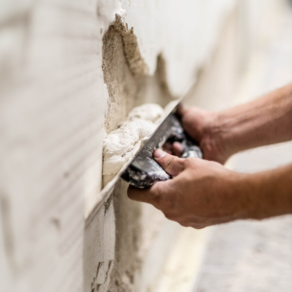 plaster being applied to large crack